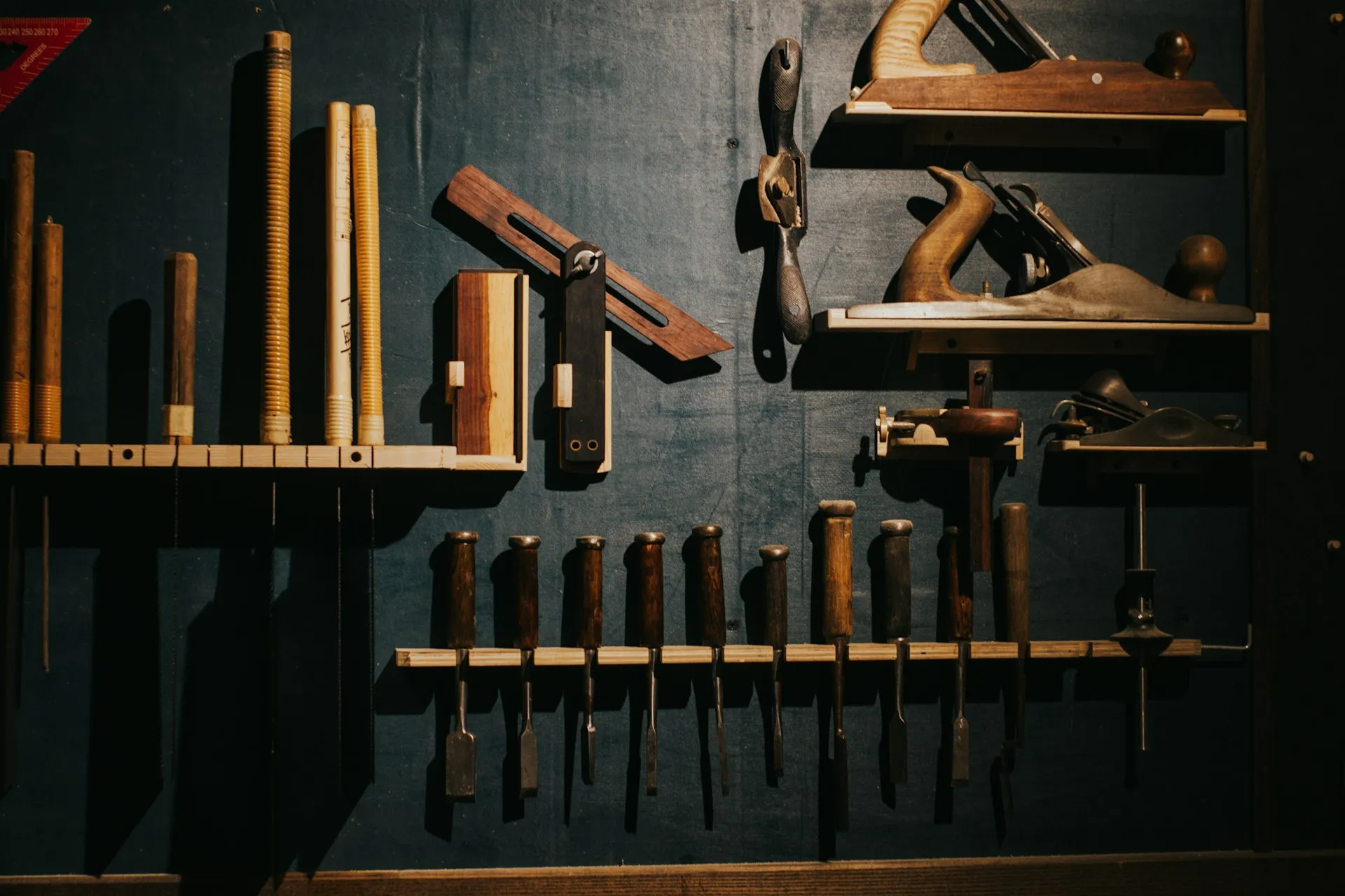 A wall of hand tools arranged in a workshop